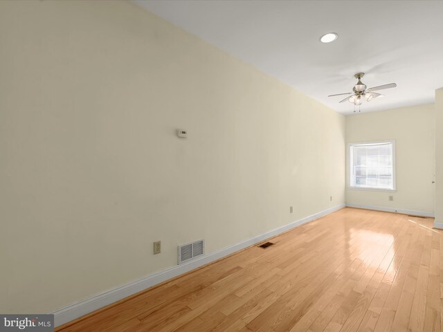 empty room with baseboards, visible vents, light wood-style flooring, and a ceiling fan