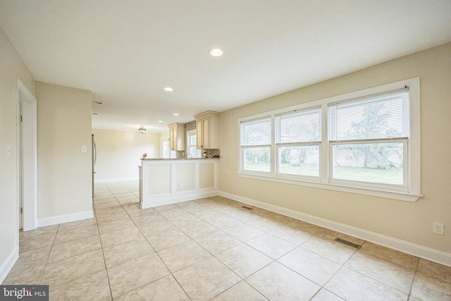 unfurnished living room featuring baseboards, visible vents, recessed lighting, and light tile patterned floors