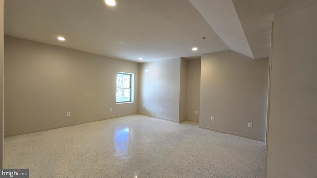spare room with speckled floor, baseboards, and recessed lighting