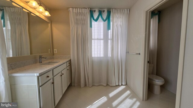 bathroom featuring toilet and vanity