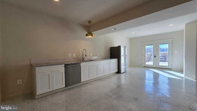 kitchen featuring white cabinets, stone countertops, appliances with stainless steel finishes, a sink, and french doors
