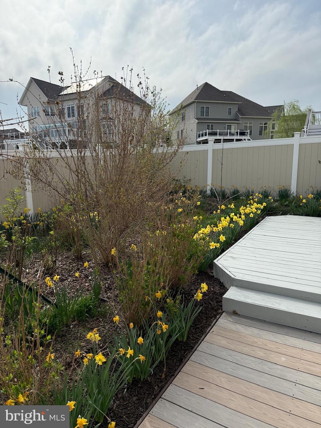 view of yard featuring a wooden deck and fence