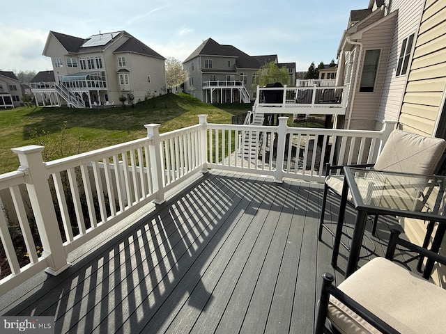 wooden deck with a yard and a residential view