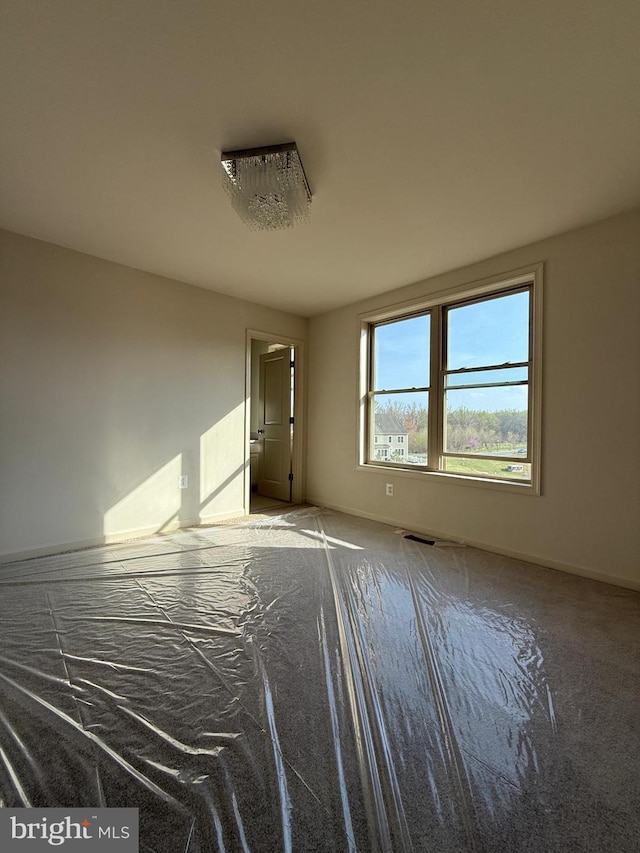 spare room featuring baseboards