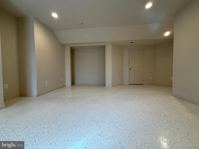 spare room with recessed lighting, baseboards, and speckled floor