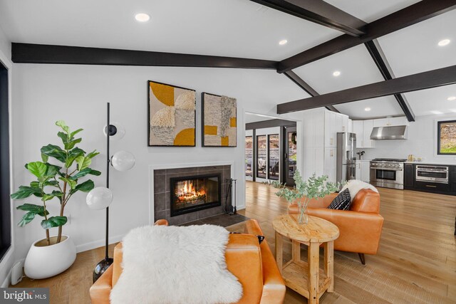 1335 N Pegram St N, Alexandria, VA 22304 - living room with a fireplace, light wood-style floors, recessed lighting, a wealth of natural light, and vaulted ceiling with beams