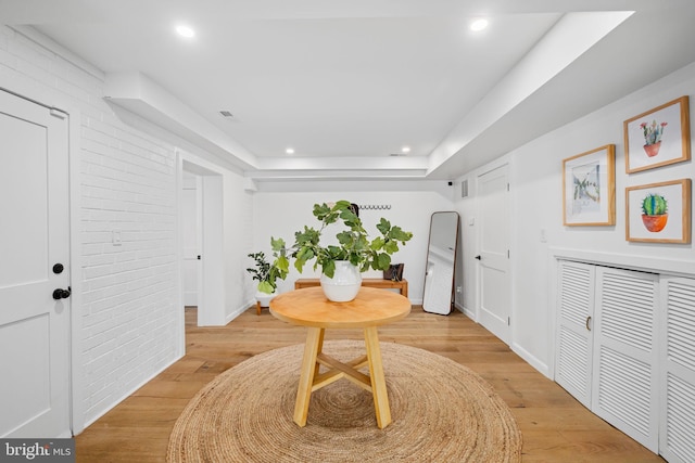 1335 N Pegram St N, Alexandria, VA 22304 - interior space with recessed lighting, brick wall, a raised ceiling, and light wood-type flooring