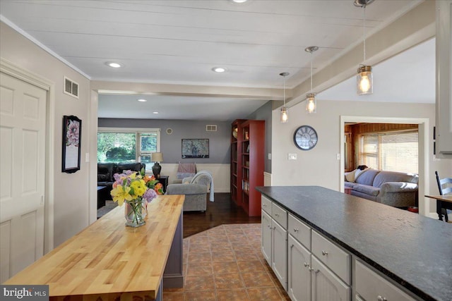 kitchen featuring decorative light fixtures, recessed lighting, open floor plan, and butcher block countertops