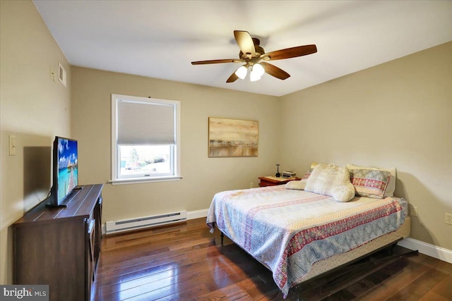 bedroom featuring ceiling fan, baseboards, a baseboard heating unit, visible vents, and hardwood / wood-style flooring