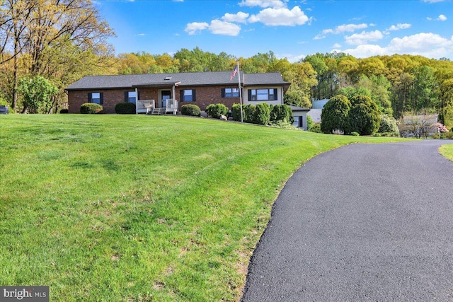 ranch-style house with a front lawn and brick siding
