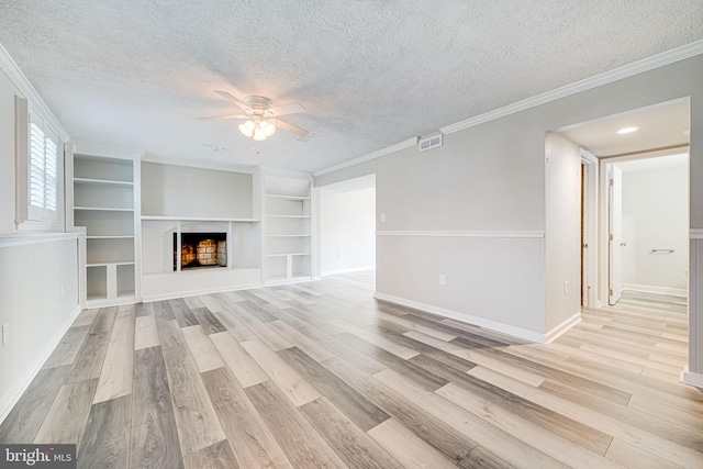 unfurnished living room featuring a textured ceiling, light wood-style floors, ceiling fan, and visible vents