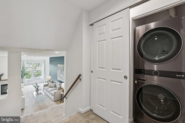 249 S Pickett St Unit 302, Alexandria, VA 22304 - washroom featuring stacked washer and clothes dryer, carpet floors, and baseboards