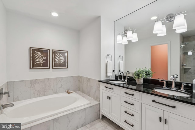 249 S Pickett St Unit 302, Alexandria, VA 22304 - full bath with double vanity, a bath, marble look tiles, a stall shower, and recessed lighting