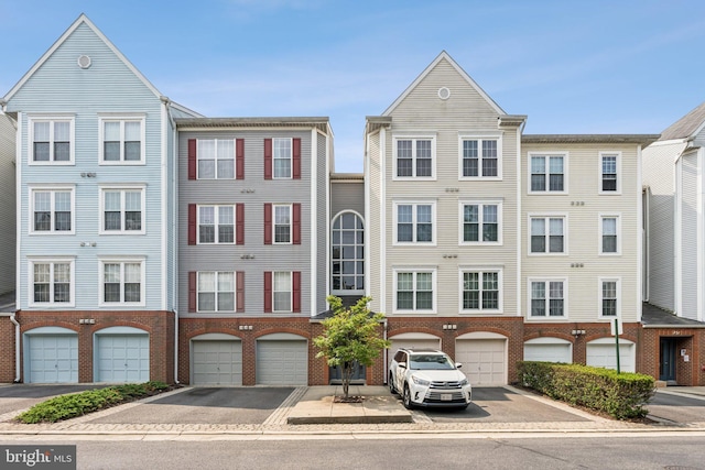 249 S Pickett St Unit 302, Alexandria, VA 22304 - view of building exterior featuring driveway and an attached garage