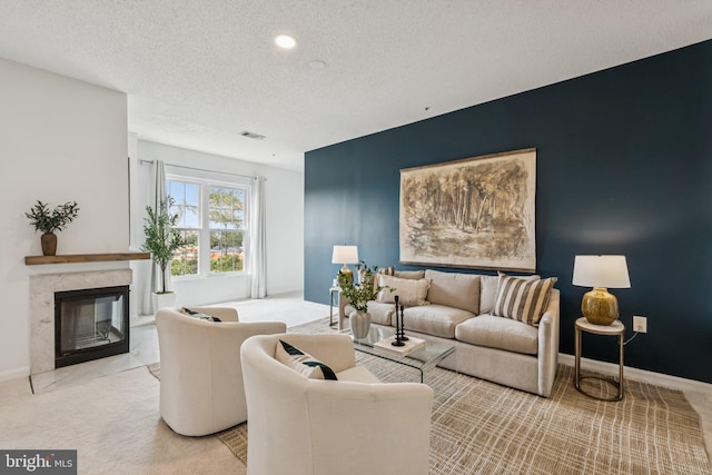 249 S Pickett St Unit 302, Alexandria, VA 22304 - living room with light colored carpet, a textured ceiling, a fireplace, baseboards, and recessed lighting