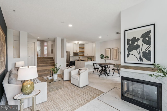 249 S Pickett St Unit 302, Alexandria, VA 22304 - living area with stairs, recessed lighting, and light carpet