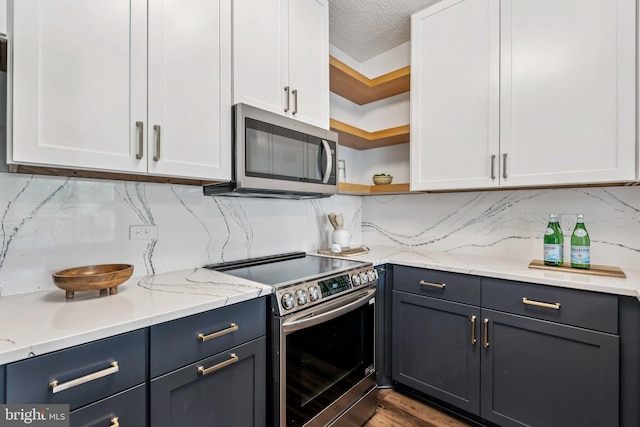 249 S Pickett St Unit 302, Alexandria, VA 22304 - kitchen featuring appliances with stainless steel finishes, open shelves, white cabinetry, decorative backsplash, and a textured ceiling