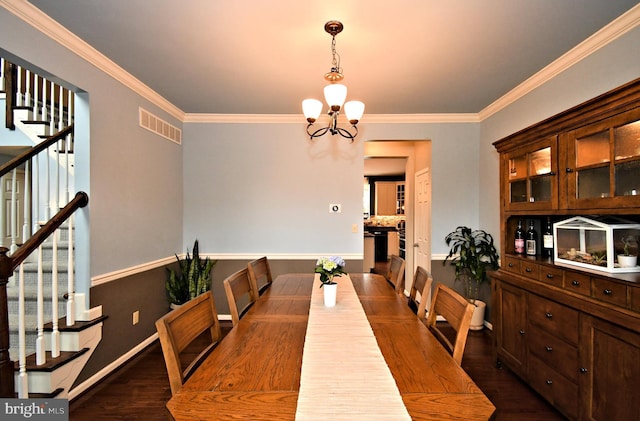 dining area with visible vents, a notable chandelier, dark wood-style flooring, ornamental molding, and stairs