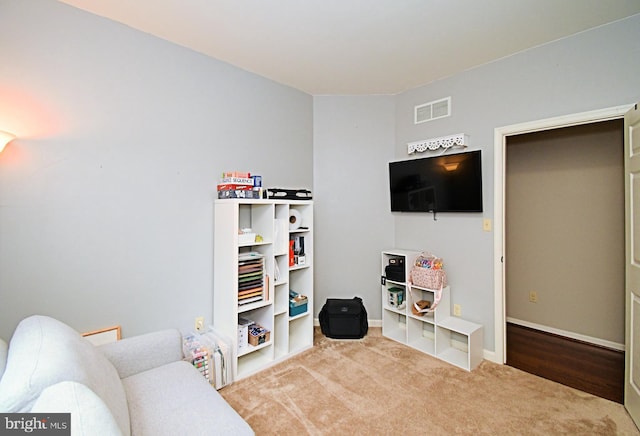 recreation room featuring carpet flooring, visible vents, and baseboards