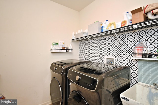 laundry room featuring a sink, separate washer and dryer, and laundry area