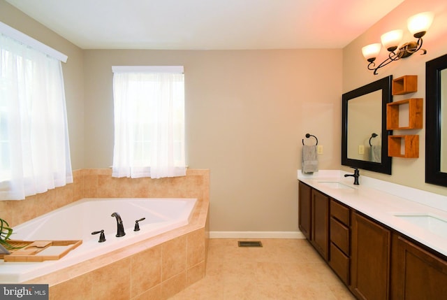 bathroom featuring visible vents, a bath, a sink, double vanity, and tile patterned flooring