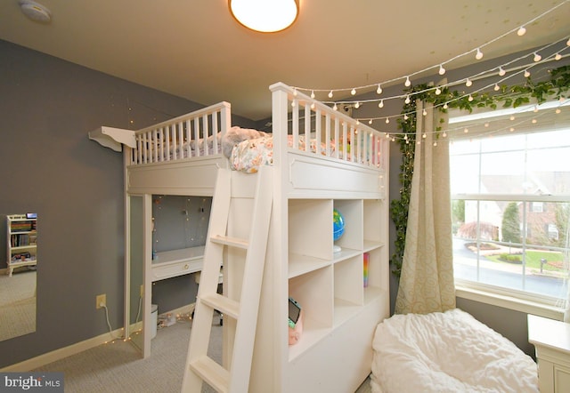 carpeted bedroom with baseboards and multiple windows