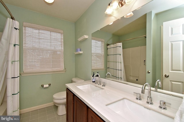 full bathroom featuring tile patterned flooring, baseboards, a sink, and toilet