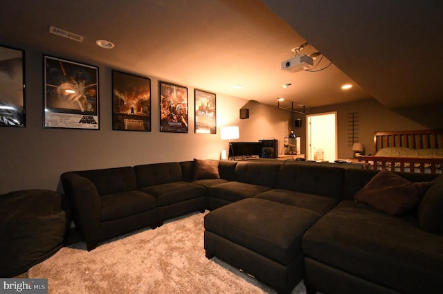 living area featuring recessed lighting, visible vents, and carpet floors