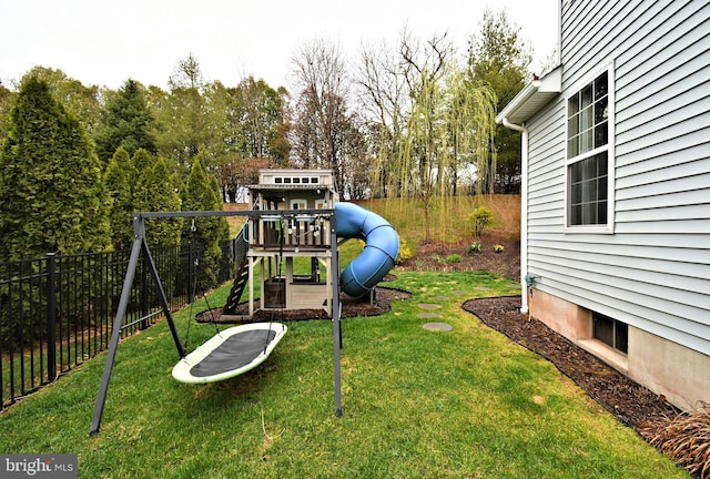 exterior space featuring fence and a playground