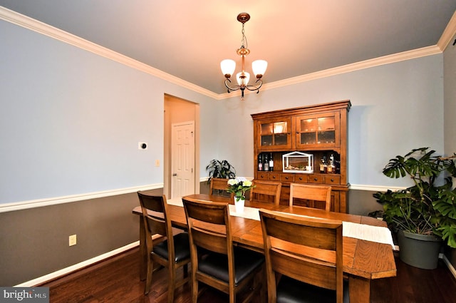 dining space with wood finished floors, an inviting chandelier, baseboards, and ornamental molding