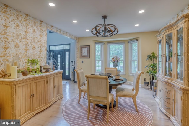 dining room featuring wallpapered walls, baseboards, an accent wall, recessed lighting, and a chandelier