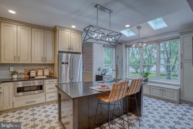 kitchen featuring stainless steel appliances, light floors, a skylight, plenty of natural light, and recessed lighting