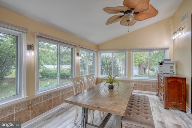 sunroom / solarium featuring vaulted ceiling and wood finished floors