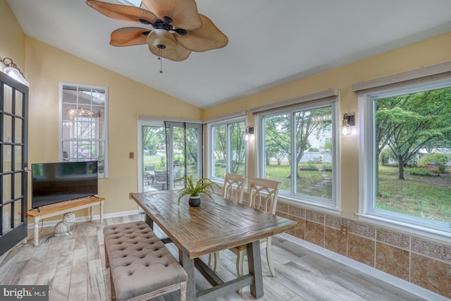sunroom featuring lofted ceiling and wood finished floors