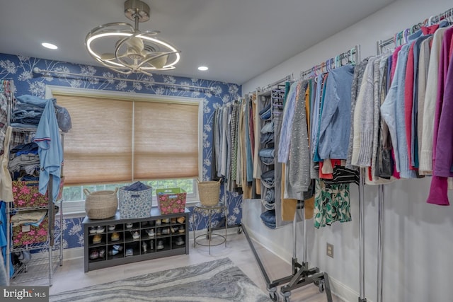 walk in closet with a chandelier