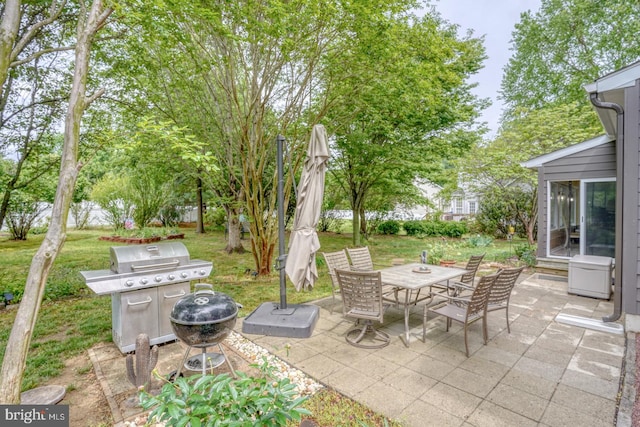 view of patio with grilling area and outdoor dining area