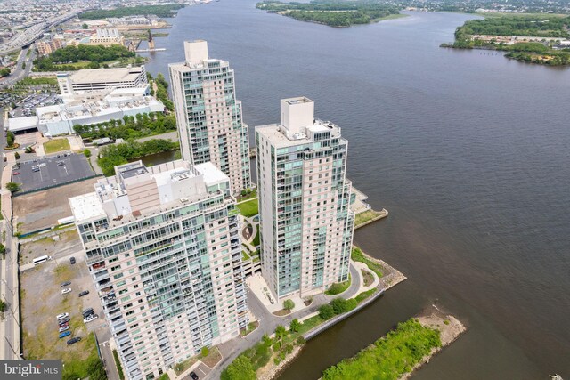 birds eye view of property with a view of city and a water view