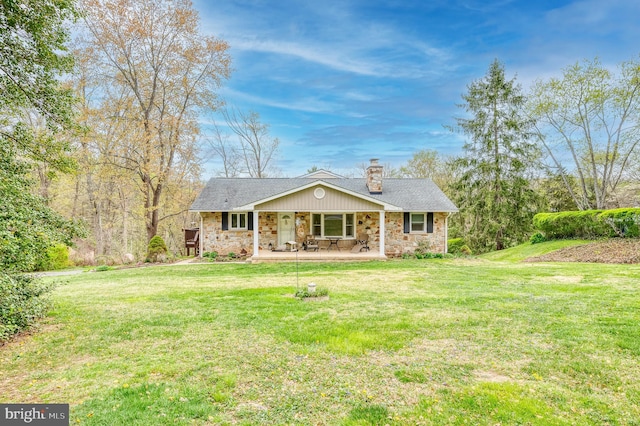 view of front of house featuring a chimney, a front lawn, a porch, and stone siding