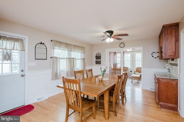 dining space with a ceiling fan, visible vents, and plenty of natural light