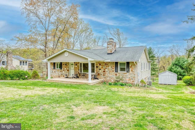 view of front of property featuring stone siding, a front lawn, and a chimney
