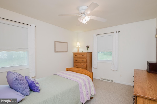 bedroom with visible vents, carpet flooring, baseboards, and a ceiling fan