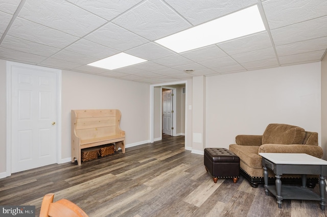 sitting room with baseboards and wood finished floors