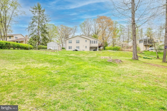 view of yard with a garage and a wooden deck