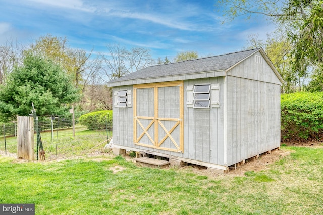 view of shed with fence