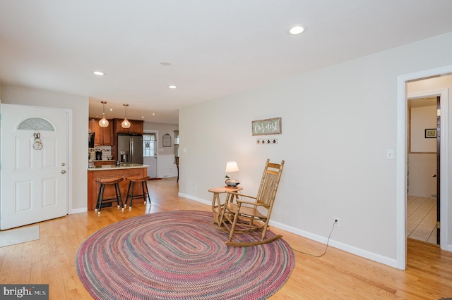 interior space featuring recessed lighting, light wood-type flooring, and baseboards