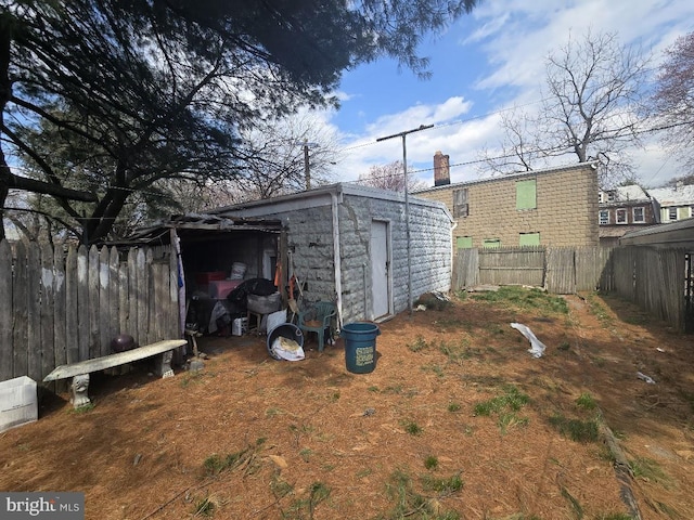 view of outbuilding featuring an outbuilding and fence