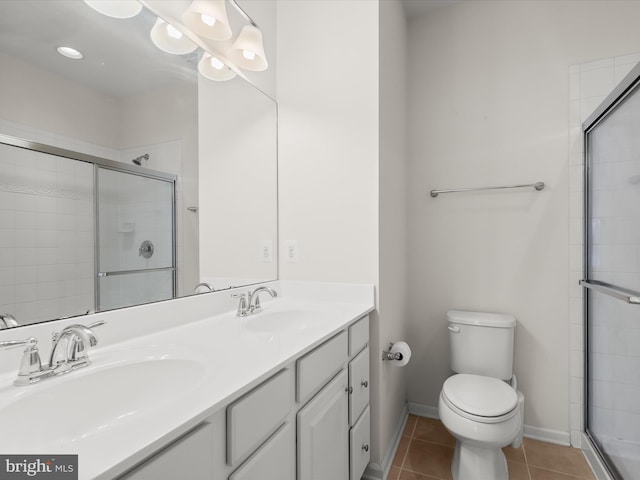 bathroom featuring a shower stall, tile patterned flooring, and a sink