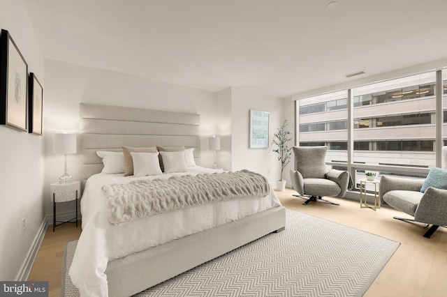 bedroom featuring wood finished floors and baseboards
