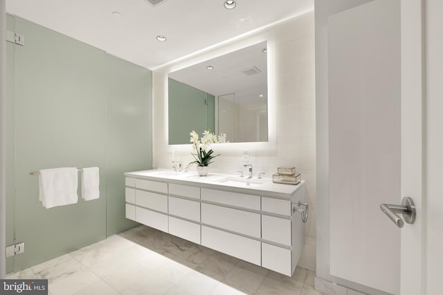 full bathroom featuring double vanity, marble look tiles, recessed lighting, and decorative backsplash