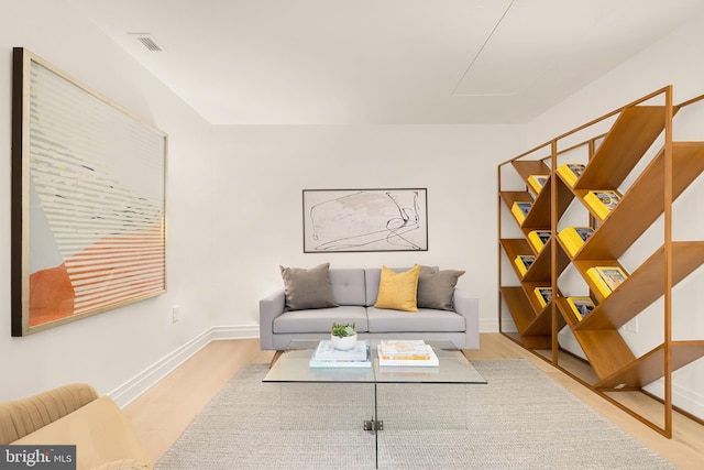 living area with wood finished floors and baseboards